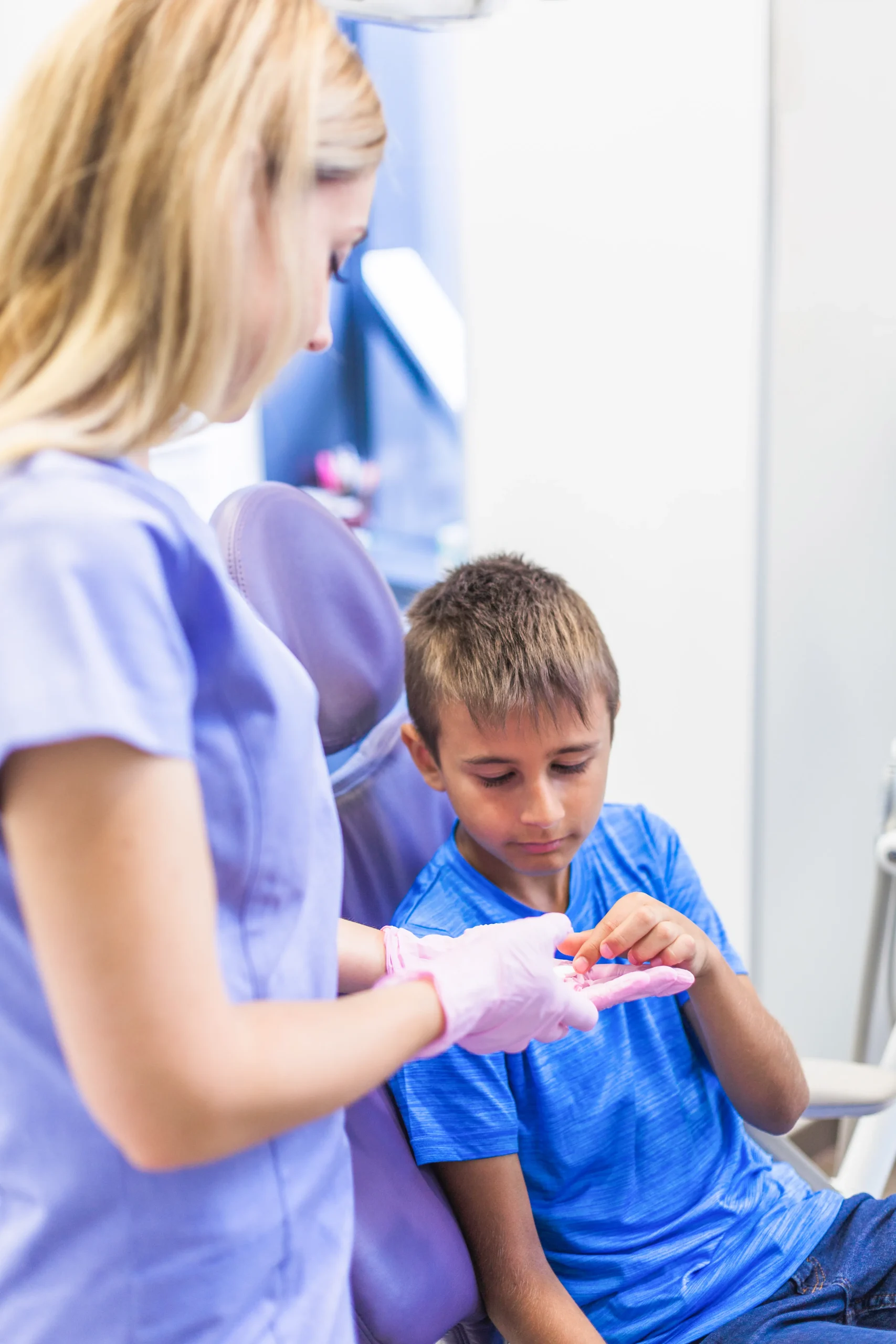 female-dentist-giving-pills-boy-clinic (1)